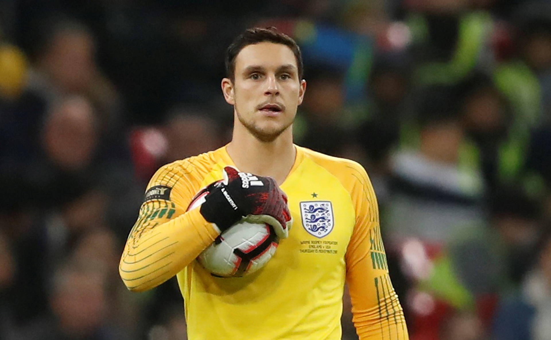 Professional Alex McCarthy Holding A Soccer Ball Screen Background